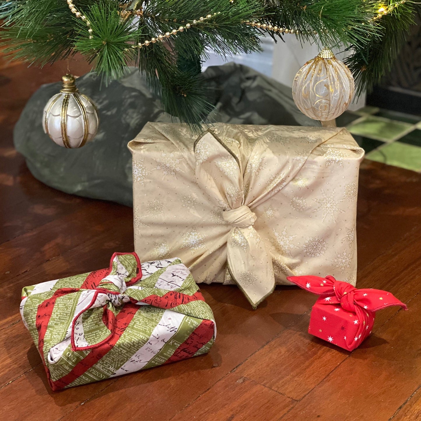 Fabric gift wrapping set . This set includes 3 sizes, large, medium and small. These are 3 knot tie wraps and there are no sacks in the set. Fabric includes a cream covered in gold and white snowflakes, a red covered with 2 toned red and white mini stars on it and a striped red, olive and white newspaper print pattern.