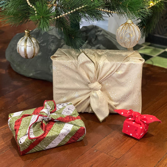 Fabric gift wrapping set . This set includes 3 sizes, large, medium and small. These are 3 knot tie wraps and there are no sacks in the set. Fabric includes a cream covered in gold and white snowflakes, a red covered with 2 toned red and white mini stars on it and a striped red, olive and white newspaper print pattern. 